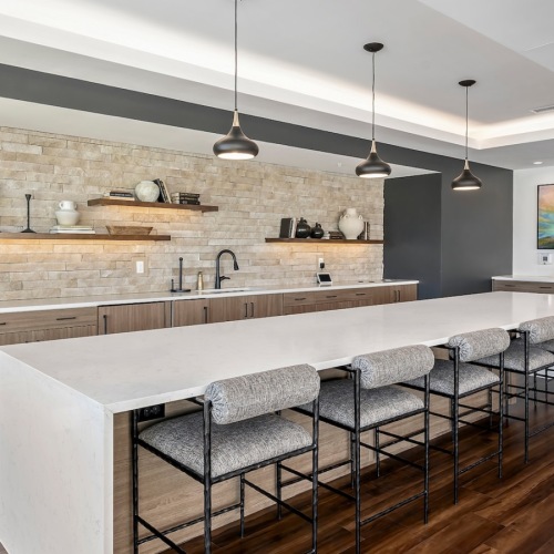 a large kitchen with a table and seating