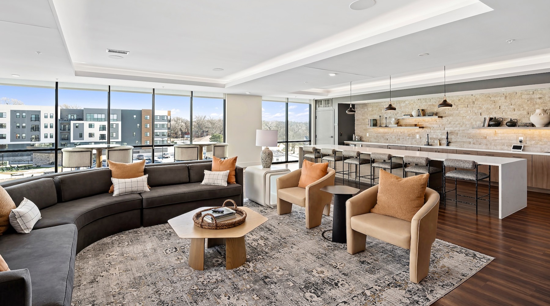 a large lounge with seating and a kitchen